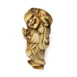 A Japanese Ivory Netsuke, Edo period, as Gama Sennin standing holding a baby toad, the toad on his