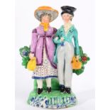 A Staffordshire Pearlware Figure Group of the Dandies, early 19th century, the fashionably dressed
