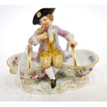 A Meissen Porcelain Figural Twin Salt, circa 1900, modelled as a boy sitting on two flower encrusted