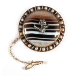 A Victorian Banded Agate and Diamond Brooch, a rose cut diamond set flower inset to a circlar banded
