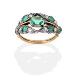 A Nineteenth Century Emerald and Diamond Ring, an octagonal cut emerald in a rubbed over setting,