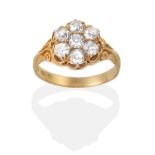 An 18 Carat Gold Old Cut Diamond Cluster Ring, in a carved setting, total estimated diamond weight