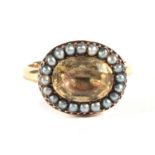 A Georgian Citrine and Seed Pearl Ring, a foil backed citrine within a border of seed pearls, finger