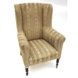 A Late George III Wing-Back Chair, early 19th century, recovered in cream stiped velvet, with