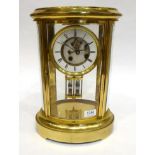 An Oval Shaped Brass Four Glass Mantel Clock, circa 1890, bevelled glass panels, 4-1/2-inch enamel