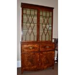 A George III Mahogany, Boxwood and Ebony Strung Secretaire Bookcase, early 19th century, the