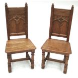 A Pair of Victorian Gothic Revival Hall Chairs, the panelled backs with Gothic tracery above boarded
