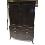 A Mahogany Linen Press, circa 1820, the moulded cornice above two moulded cupboard doors enclosing