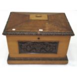 A Victorian Oak Wine Cooler, the hinged lid above a pine lined interior, the front carved in