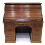 A Victorian Mahogany Roll-Top Desk, late 19th century, the tambour front enclosing a fitted interior