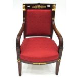 A Mahogany and Gilt Metal Mounted Armchair, late 19th century, in Empire style, recovered in red