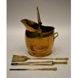 A Brass Coal Helmet, 19th century, 42cm wide; and Three Brass Fire Irons (4)