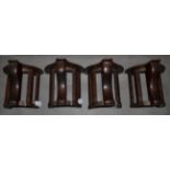 A Set of Four Cast Iron and Mahogany Musgrave's Patent Bridle Racks, early 20th century, with turned
