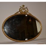 An Early 19th Century Gilt and Gesso Oval Mirror, the bevelled glass plate within a reeded frame