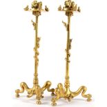 A Pair of Gilt Bronze Candlesticks, 19th century, with leaf cast sockets on squared drip pans
