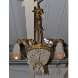 A French Gilt Metal and Cut Glass Three-Branch Four-Light Electrolier, with scroll branches, moulded