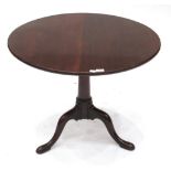 A George III Mahogany Fliptop Tripod Table, 3rd quarter 18th century, the circular top above a