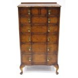 A 1920s Figured Walnut and Crossbanded Chest, of serpentine shaped form, the moulded top above six