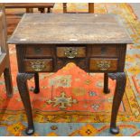 An 18th Century Oak Dressing Table, the moulded top above three small drawers and an arched apron,