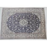 Nain Part Silk Carpet Central Iran, circa 1960 The indigo field of scrolling vines around a