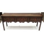 A George III oak and crossbanded low dresser, moulded top above three drawers with brass swan neck
