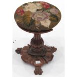 A Victorian Carved Rosewood Revolving Piano Stool, mid 19th century, with original worn needlework