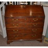 A George III Oak Bureau, late 18th century, the fall enclosing a fitted interior of pigeon holes,