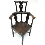 An Early 19th Century Ash Corner Armchair, the back support with a pierced splat above curved
