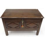 A Late 17th Century Joined Oak Chest, the hinged lid above two lozenge carved panels, on stile feet,