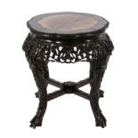 An Early 20th Century Chinese Hardwood and Pink Marble Plant Stand, the foliate carved apron on