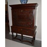A 17th Century Carved Walnut Escritoire, with a cushion shaped drawer above a relief carved panel