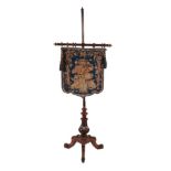 A Victorian Carved Walnut Pole Screen, circa 1870, with blue and floral needlework banner