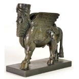 After the Antique: A Bronze Figure of Lamassu, the standing mythical winged creature on a