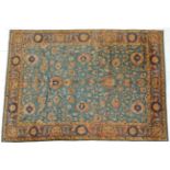 Indian Carpet, 20th century The green/blue field with an allover design of palmettes and vines