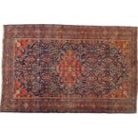 Feraghan Rug West Iran, circa 1925 The indigo lattice field with central terracotta medallion framed