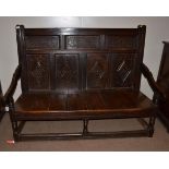 A Joined Oak Panel Back Settle, late 17th/early 18th century, with three geometric decorated