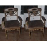 A Pair of Early 20th Century French Wrought Iron Armchairs, recovered in vintage brown leather,