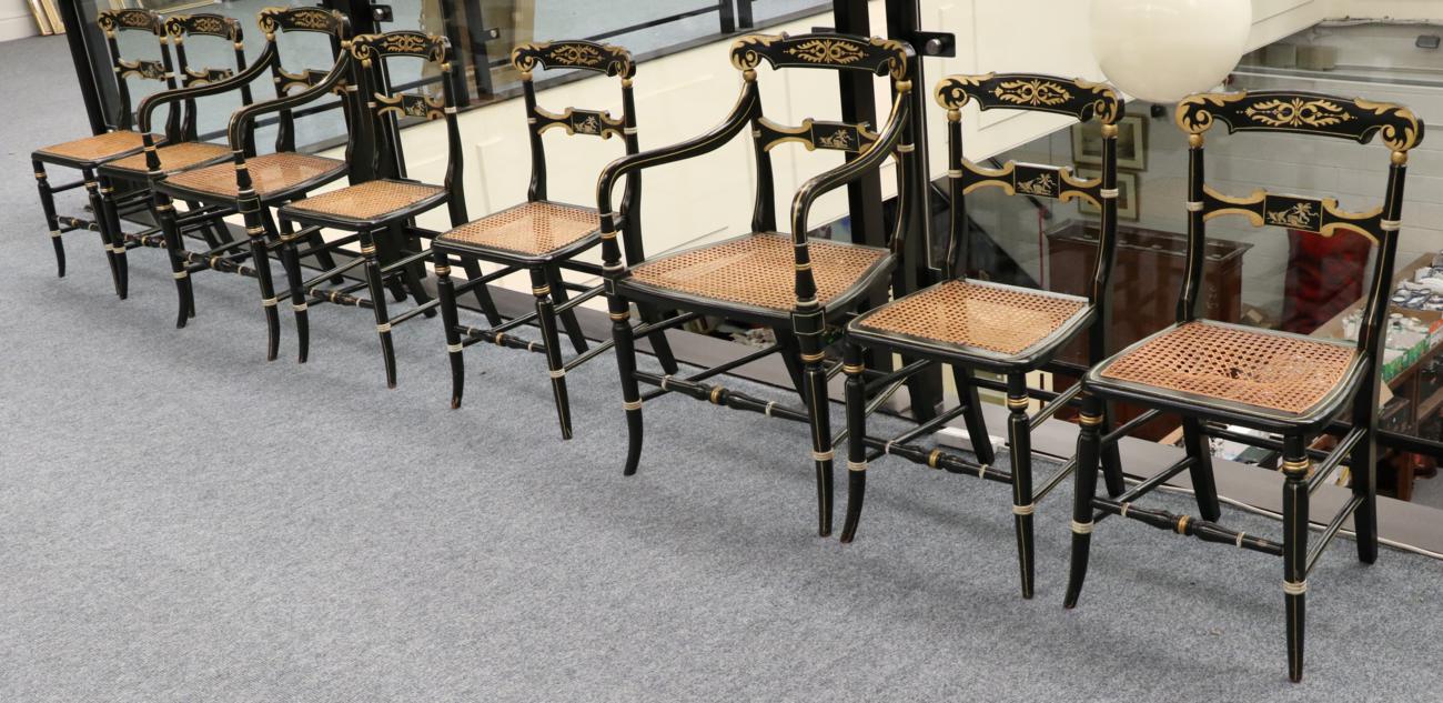 A Set of Eight Regency Cane-Seated Dining Chairs, circa 1820, decorated in parcel gilt with acanthus