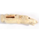 A Carved Horn Dog Whistle, circa 1900, in the form of the head of a hound with glass eyes, 7cm long