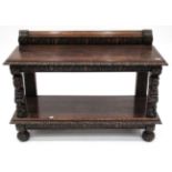 A Victorian Carved Oak Two-Tier Serving Table, mid 19th century, the moulded top with a stiff leaf