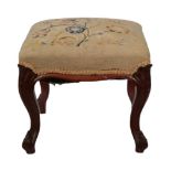 A Victorian Carved Mahogany Dressing Stool, circa 1870, with later floral needlework seat above a