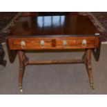 A Regency Mahogany Sofa Table, with two rounded drop leaves above four frieze drawers, on spiral