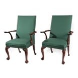 A Pair of Carved Mahogany Open Armchairs, recovered in green close-nailed fabric, with curved