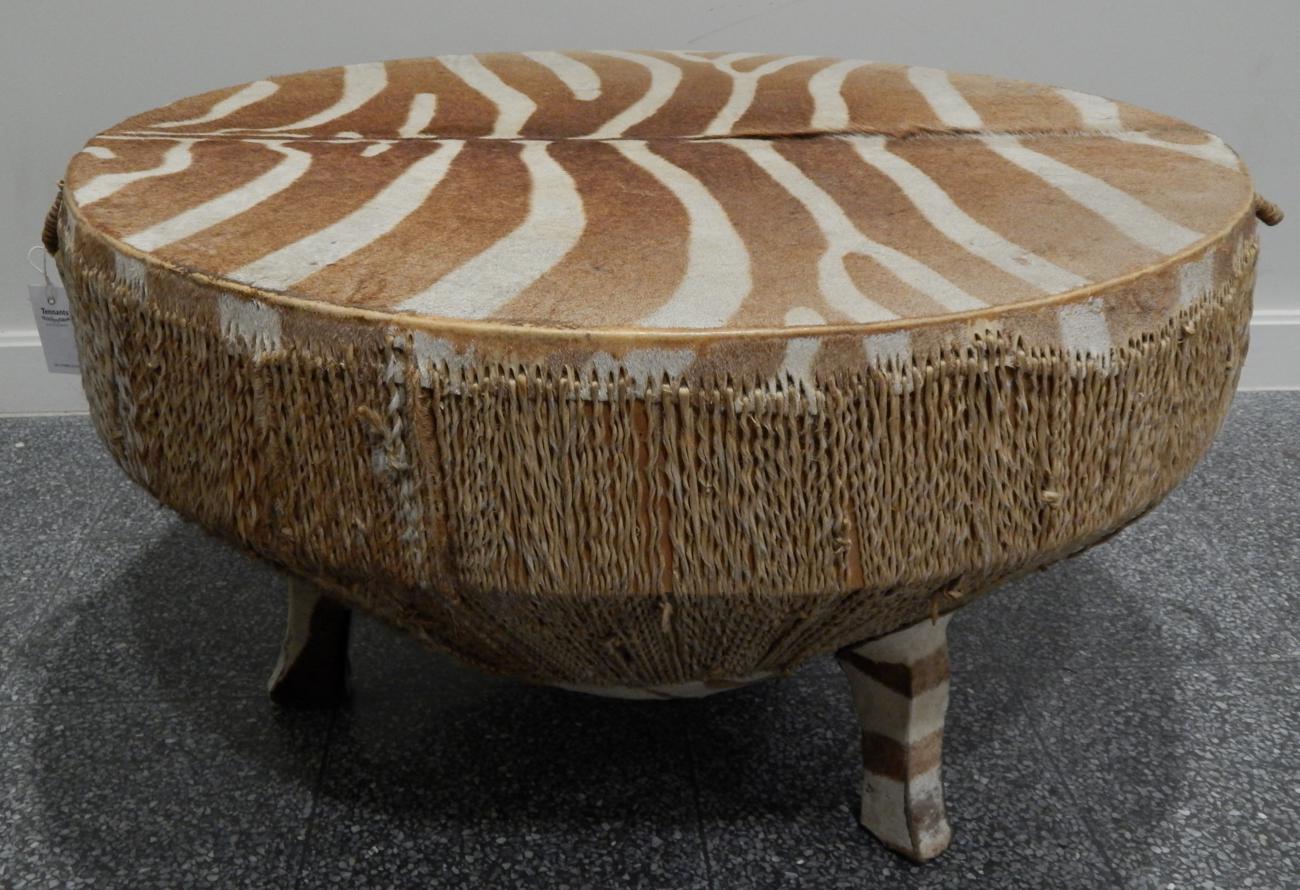 A large circular Zebra hide drum table, circa 1960-70, of circular form raised upon three feet, 88cm