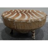 A large circular Zebra hide drum table, circa 1960-70, of circular form raised upon three feet, 88cm