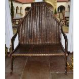 Rajasthan: A Hardwood and Metal Mounted Two-Seater Bench, with decorative strapwork throughout,