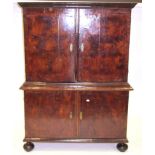 A Walnut and Featherbanded Cupboard, the bold cornice above two cupboard doors with moulded base,