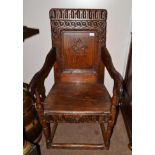 A 17th Century Joined Oak Wainscot Armchair, the nulled top rail and guilloche carved back support
