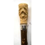 A Victorian Silver and Japanese Ivory Mounted Walking Stick, London 1885, the handle carved in