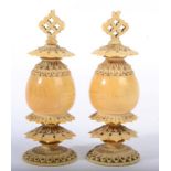 A Pair of Ivory Finials, late 19th century, of ovoid form with angular pierced borders, 9cm,